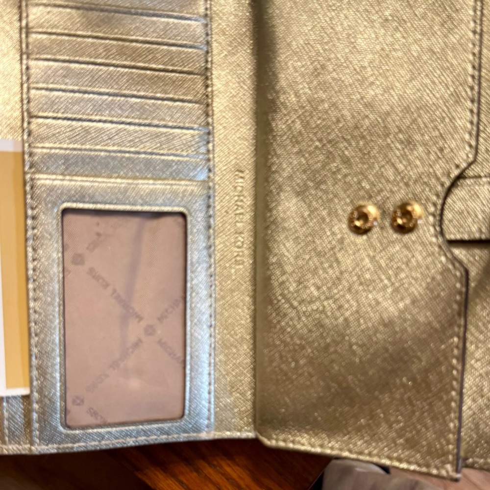 NWOT. Never used monogrammed Michael Kors Jet Set Wallet Wristlet. Phone pocket.